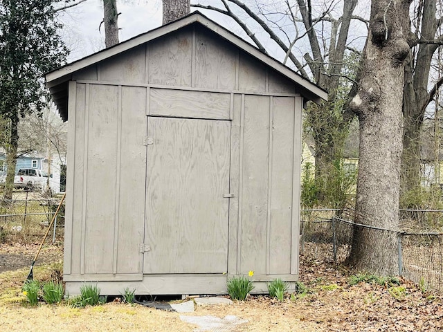 view of shed featuring fence