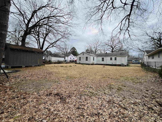 view of yard featuring fence and an outdoor structure