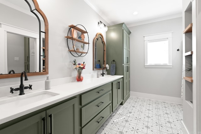 bathroom with double vanity, baseboards, ornamental molding, and a sink