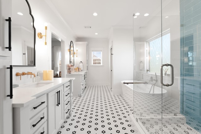 bathroom with visible vents, two vanities, a sink, a shower stall, and a tub