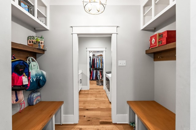 mudroom with a chandelier, baseboards, and light wood finished floors