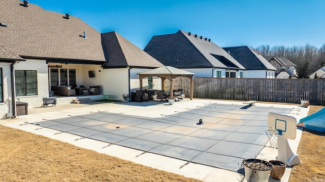 view of swimming pool featuring a patio area, fence, and a gazebo