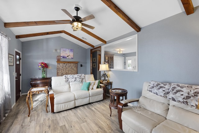 living room with ceiling fan, lofted ceiling with beams, and wood finished floors