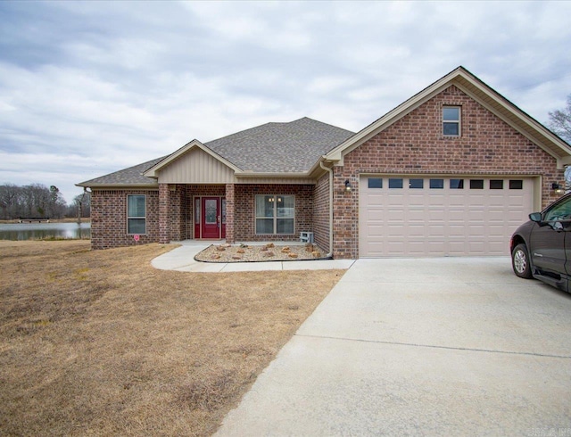 single story home with a shingled roof, concrete driveway, an attached garage, a front lawn, and brick siding