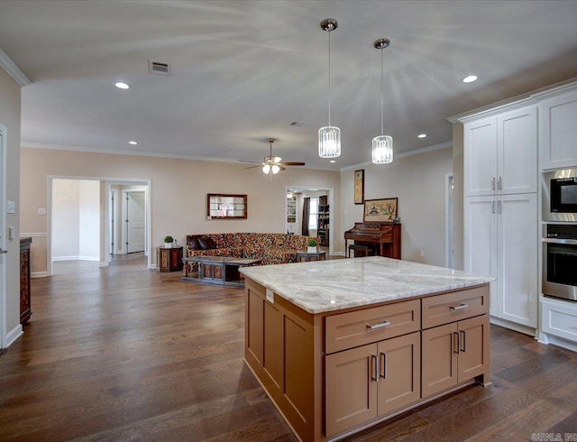 kitchen featuring ornamental molding, appliances with stainless steel finishes, dark wood-type flooring, and visible vents