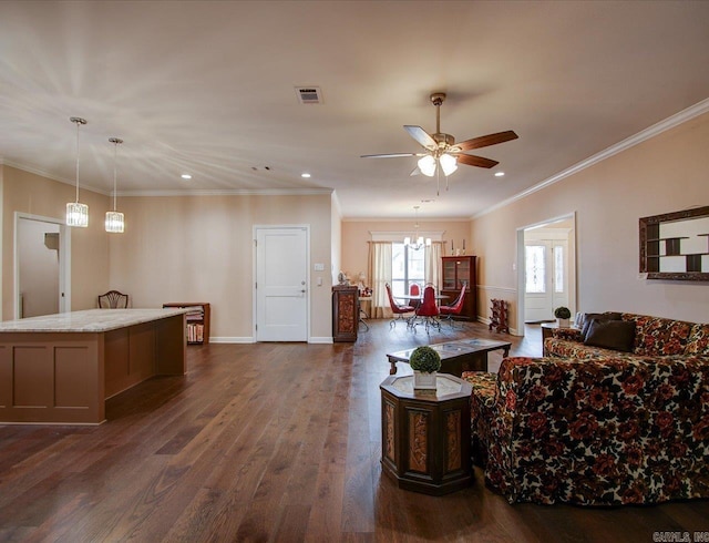 living area with ceiling fan with notable chandelier, dark wood-style flooring, visible vents, baseboards, and crown molding