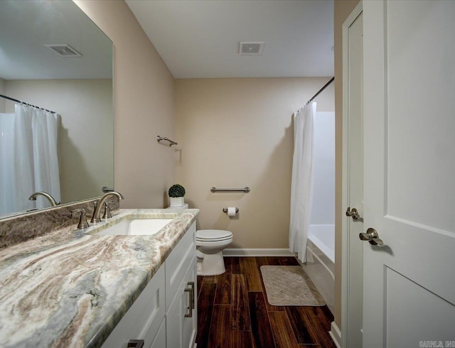 full bath featuring visible vents, vanity, toilet, and wood finished floors