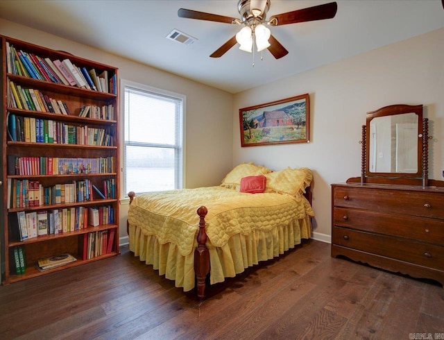 bedroom featuring dark wood-style flooring, visible vents, and baseboards