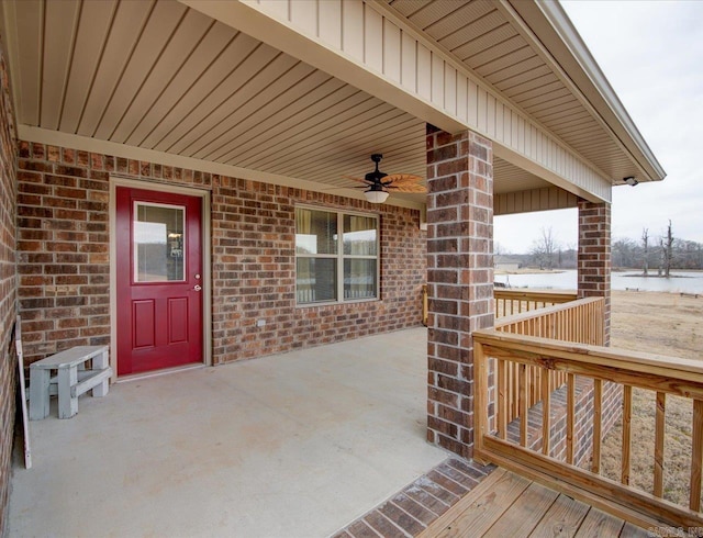 exterior space with a patio, a water view, and a ceiling fan