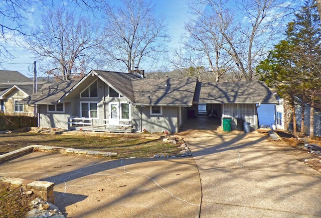 single story home featuring driveway and a chimney