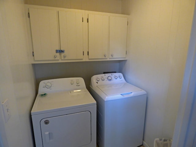 laundry area with cabinet space and separate washer and dryer