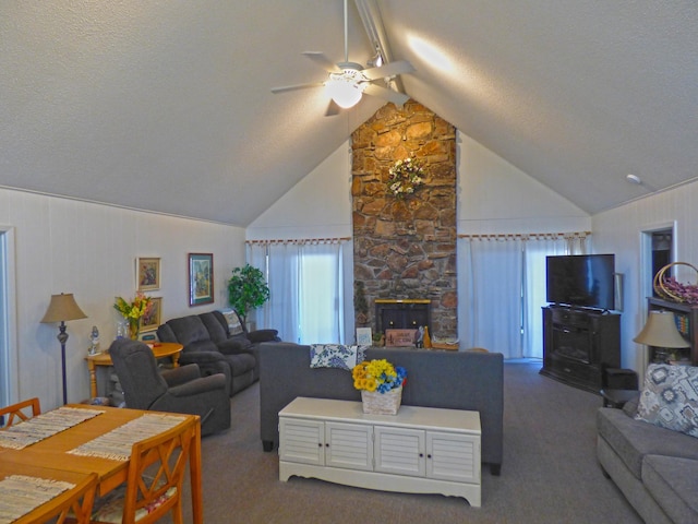 living area featuring ceiling fan, a textured ceiling, a fireplace, vaulted ceiling, and carpet