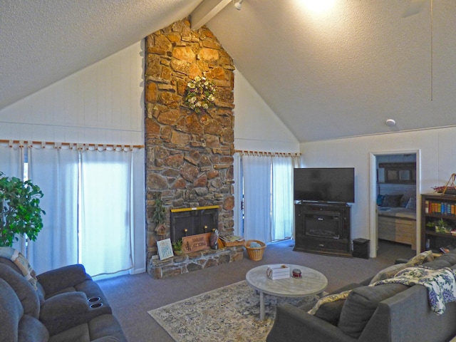 living area featuring a fireplace, lofted ceiling with beams, a healthy amount of sunlight, carpet flooring, and a textured ceiling