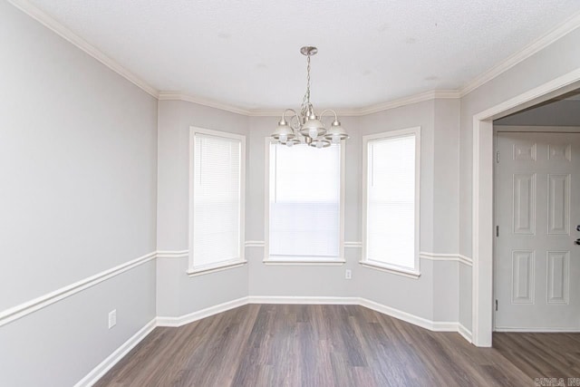 unfurnished dining area with baseboards, dark wood finished floors, crown molding, and a chandelier