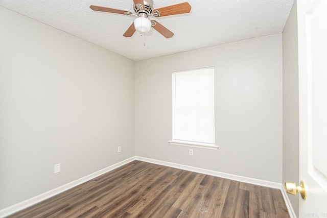 empty room featuring dark wood-style floors, a textured ceiling, a ceiling fan, and baseboards