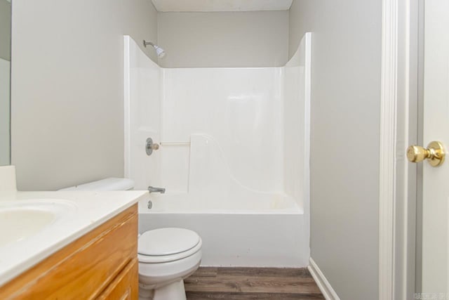 bathroom featuring shower / bath combination, vanity, toilet, and wood finished floors