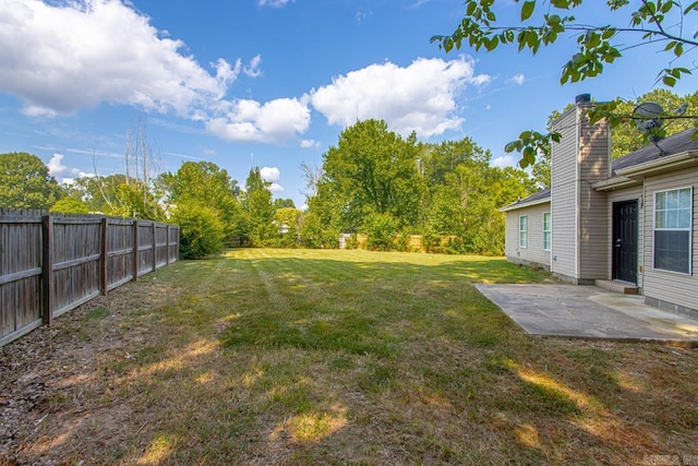 view of yard with fence and a patio