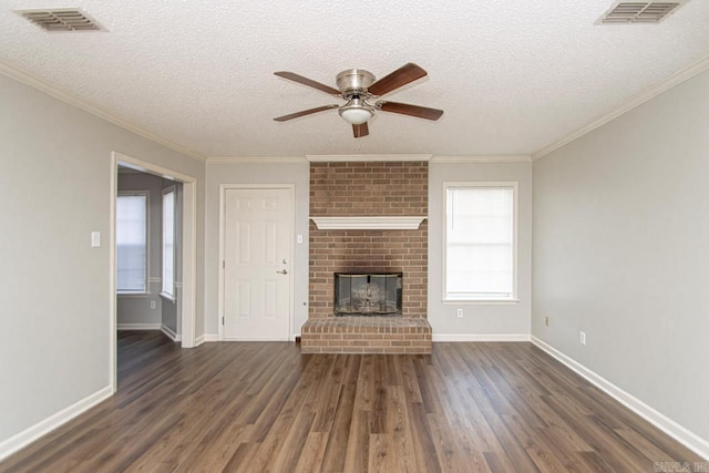 unfurnished living room with a brick fireplace, visible vents, and wood finished floors