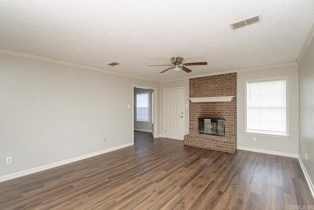 unfurnished living room featuring a fireplace, visible vents, dark wood finished floors, and crown molding