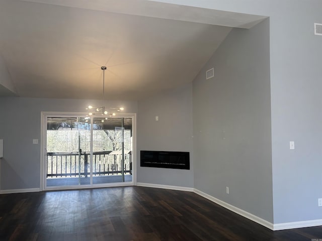 unfurnished dining area with a fireplace, dark wood finished floors, visible vents, and baseboards