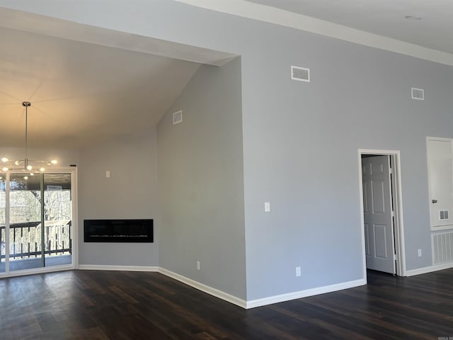 unfurnished living room featuring dark wood finished floors, visible vents, a fireplace, and baseboards