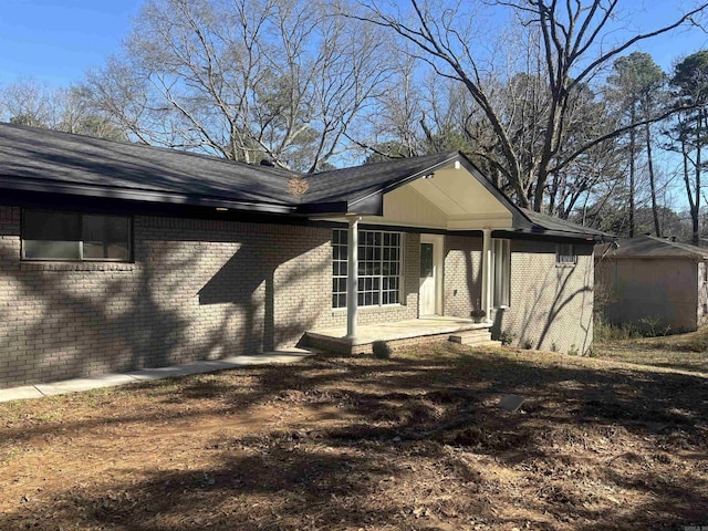 view of property exterior with brick siding