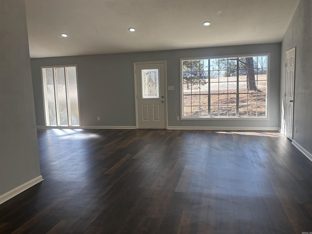 foyer featuring dark wood-style flooring, recessed lighting, and baseboards