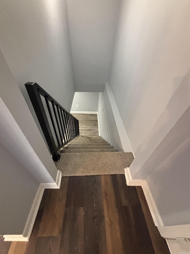 stairway featuring wood finished floors