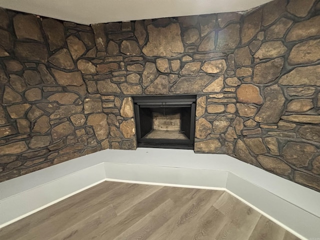 interior details with a fireplace and wood finished floors