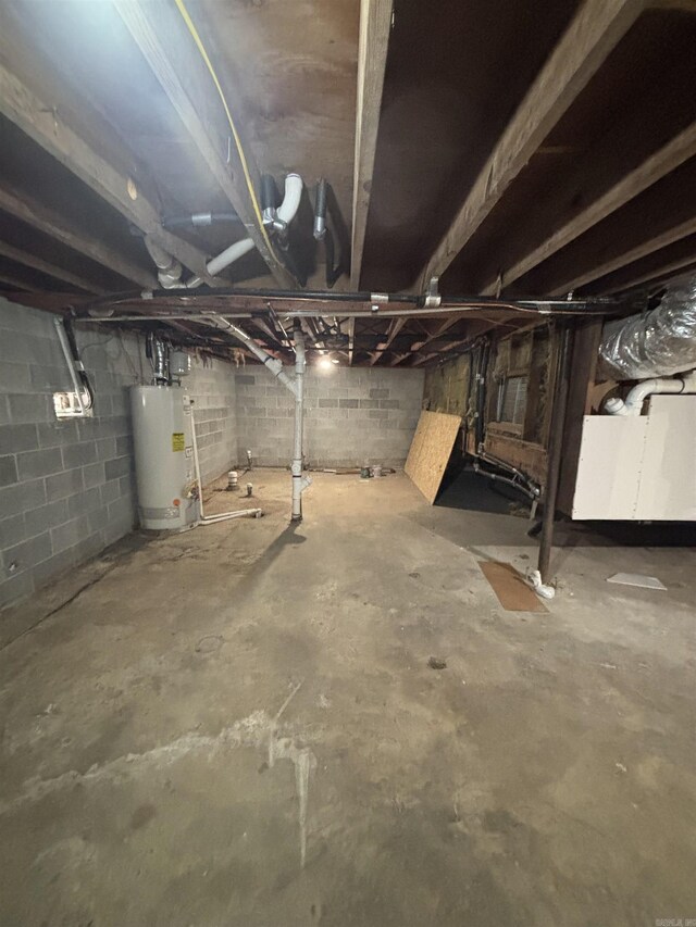 unfinished basement featuring water heater