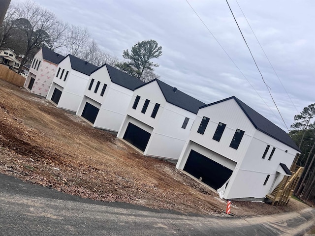 view of front of property with a garage and fence