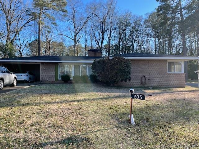 single story home with brick siding, an attached garage, a chimney, and a front lawn