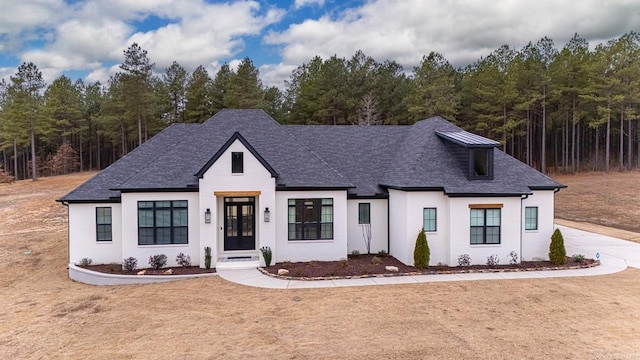 view of front of property with french doors and a shingled roof