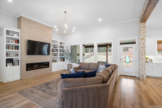 living room featuring light wood-style floors, a fireplace, and ornamental molding