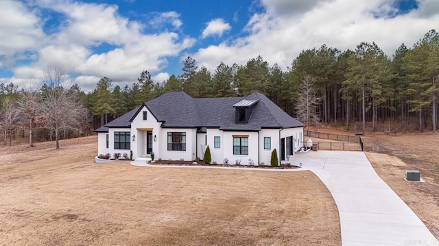 modern inspired farmhouse with driveway and roof with shingles