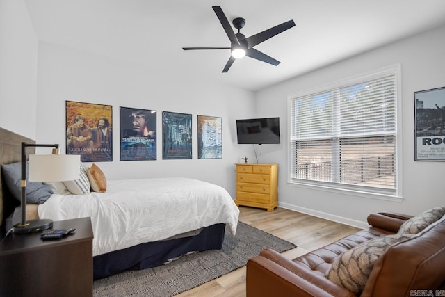 bedroom featuring ceiling fan, baseboards, and wood finished floors