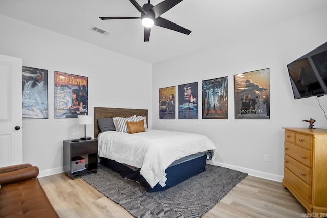 bedroom with light wood-type flooring, baseboards, visible vents, and ceiling fan