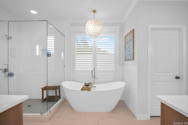 full bath featuring crown molding, recessed lighting, vanity, a shower stall, and a freestanding tub