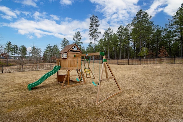 view of jungle gym featuring fence