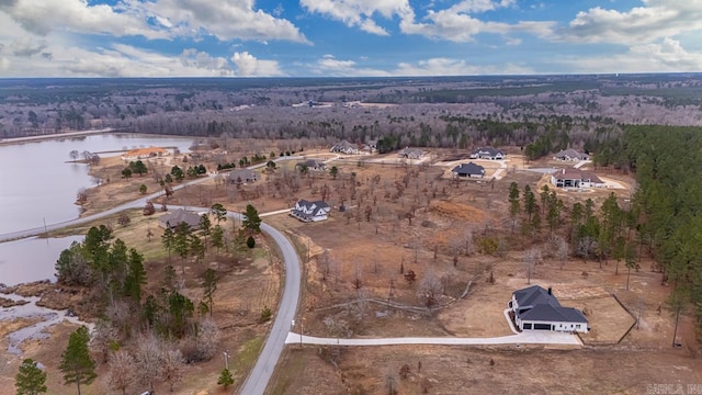 birds eye view of property with a water view and a view of trees