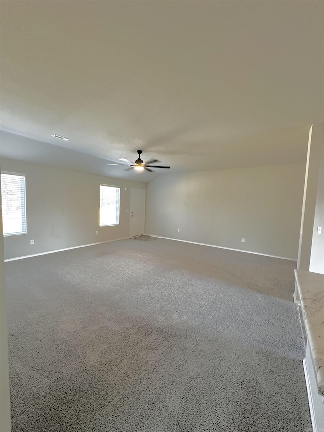 empty room with ceiling fan and baseboards