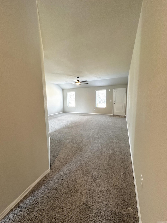 unfurnished room with ceiling fan, baseboards, and carpet flooring