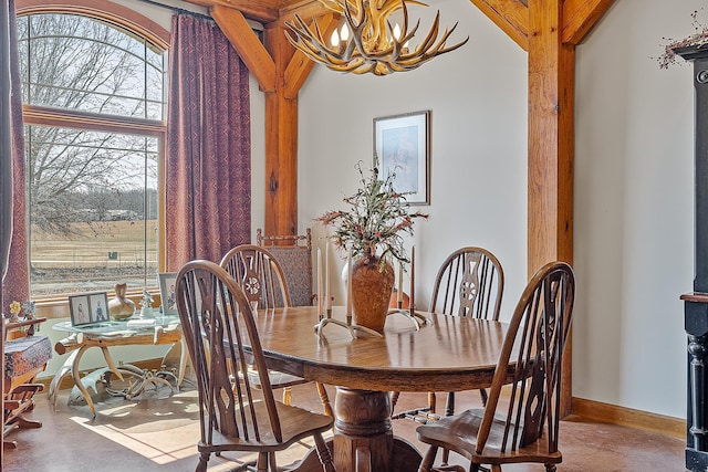 dining room with baseboards and an inviting chandelier