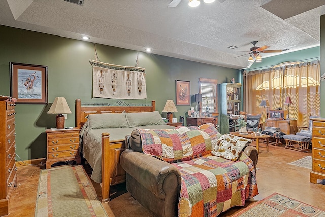 bedroom with a textured ceiling, visible vents, and a ceiling fan