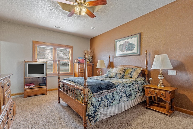 bedroom with visible vents, light colored carpet, a textured wall, and a textured ceiling