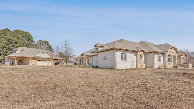 view of home's exterior featuring brick siding and roof with shingles