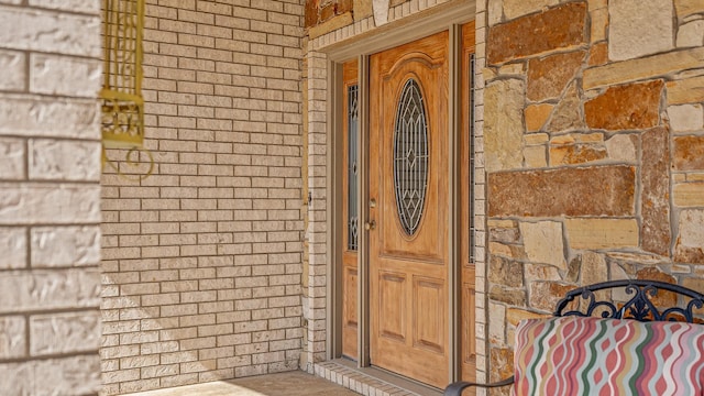 property entrance with brick siding