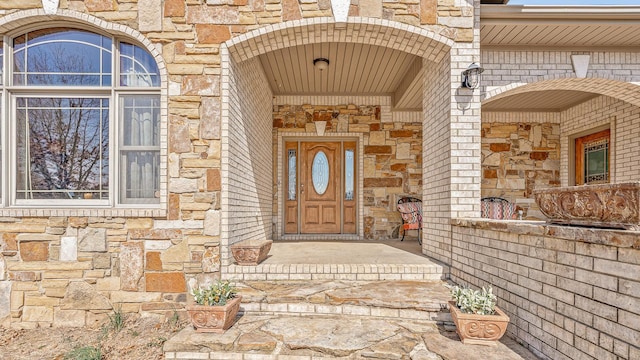 property entrance featuring stone siding and brick siding