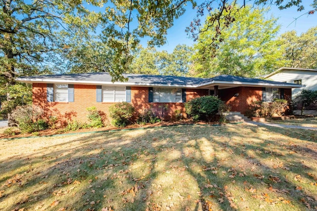 single story home with a front yard and brick siding