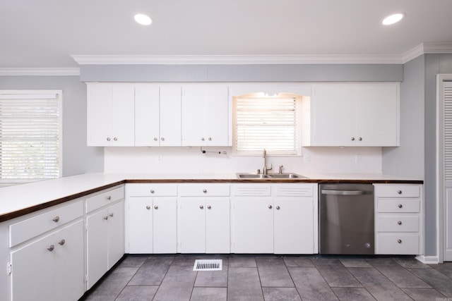 kitchen featuring visible vents, dishwasher, crown molding, white cabinetry, and a sink